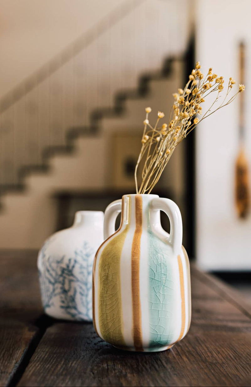 Decorative ceramic vase with striped pattern on a wooden surface