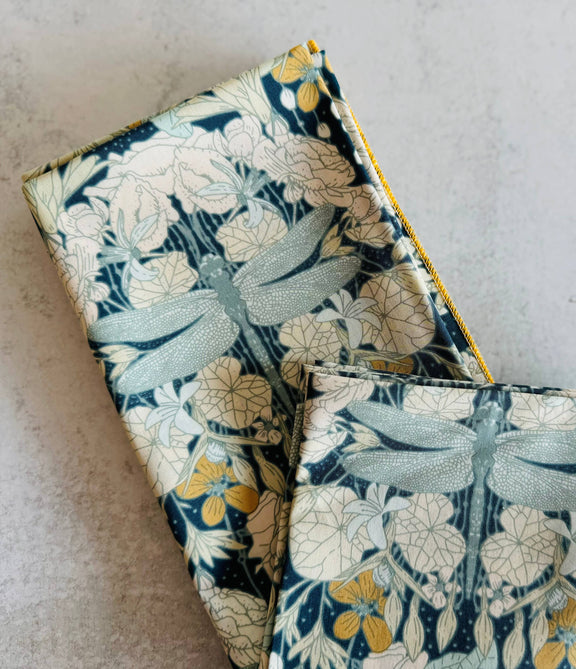 Two fabric items with dragonfly pattern on a light gray background